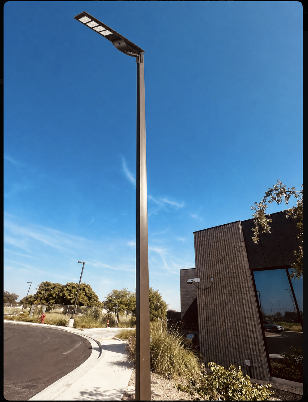 Allta Pro all-in-one solar light mounted on a square pole outside a commercial building